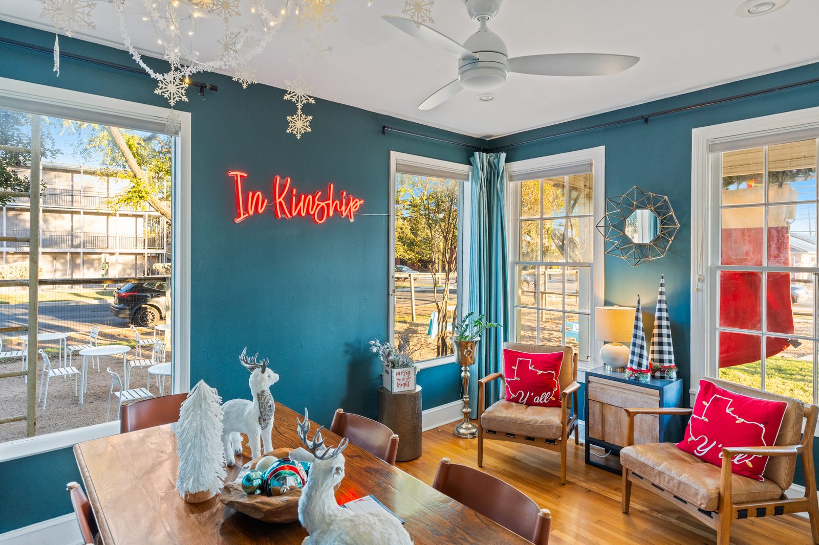 Sunroom dining with In Kinship neon sign